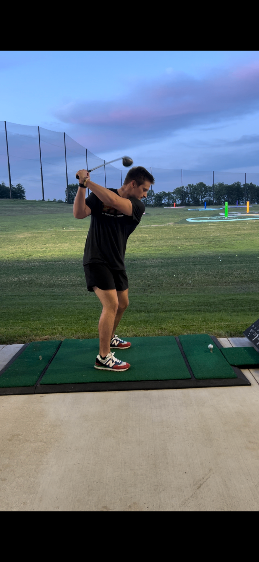 Golfer at the top of a backswing in a Flight Zone outdoor bay